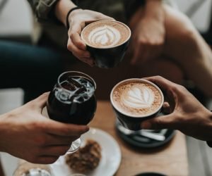 three person holding mug and glass with beverage inside